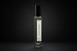 Elegant perfume bottle with a black cap and clear glass body labeled 'Secret Serenity Inspired By J'adore by Dior' against a dark background