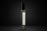 Elegant perfume bottle with a black cap and clear glass body labeled 'Secret Serenity Inspired By J'adore by Dior' against a dark background